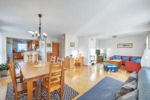 a dining room and living room with a table and chairs at King size apartmán Pension Monika in Špindlerův Mlýn