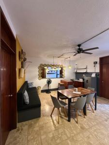 a living room with a table and a couch at HOSTAL CHOCOLATE CALENDA in Oaxaca City