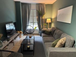 a living room with a couch and a table at La Casa De Roma in Cambados