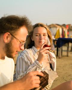 a man and a woman looking at a glass of wine at Kieh Beachfront Villa in Mandrem +42 photos
