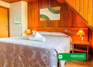 a bedroom with a bed with wooden walls at Hotel Nacional Inn Campos do Jordão in Campos do Jordão +42 photos