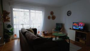 a living room with a couch and a television at BENAMAR HOUSE in Quarteira +28 photos