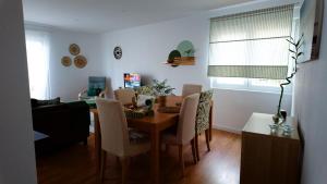 a living room with a dining room table and chairs at BENAMAR HOUSE in Quarteira