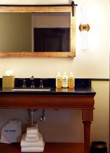 a bathroom counter with a sink and a mirror at Berkshires Untold in Lenox +45 photos