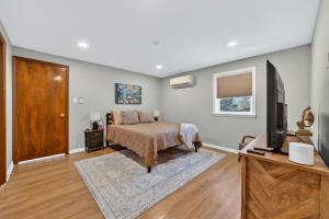 a bedroom with a bed and a flat screen tv at The Edamame House in Nazareth +43 photos