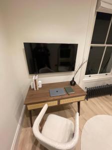 a desk with a laptop and a chair in a room at Boltons Residence Collection Hotel London in London