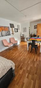 a room with a bed and a table and chairs at Cabaña Valle del Yeso in El Manzanito