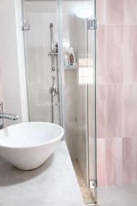 a bathroom with a glass shower with a white tub at Aurora Flavia Suite in Pozzuoli