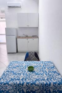 a kitchen with a table with a green bowl on it at Aurora Flavia Suite in Pozzuoli