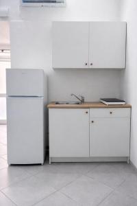 a kitchen with two white refrigerators and a sink at Aurora Flavia Suite in Pozzuoli