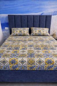 a bed with a quilt and pillows on it at Aurora Flavia Suite in Pozzuoli +1 photo