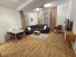 a living room with a couch and a table at Sero`s Apartment in Hahnstätten
