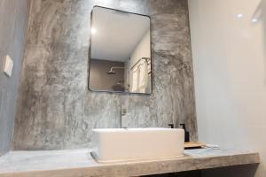 a bathroom with a sink and a mirror at Amaria Maldives in Finolhus