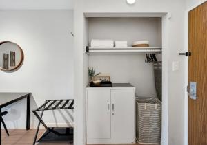 a room with white walls and a white cabinet at Modern Midtown Studio and Private Balcony in Raleigh