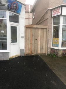 a wooden door on the side of a building at Evas place in Llandudno