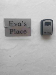 a sign on the side of a wall with a socket at Evas place in Llandudno