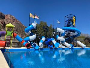 a swimming pool with a water park with a water slide at Raíces in San Rafael