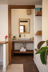 a bathroom with a sink and a mirror at The Nest - Complimentary Massage Included in Kigali