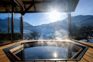 a hot tub in a house with a view of the mountains at Садиба Грицюка in Krivorovnya
