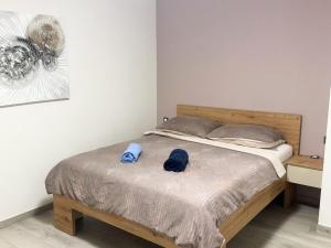 a bed with two blue hats on top of it at Villa Majra in Valbandon +72 photos
