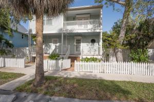 a white house with a white picket fence at ISLAND TIME ON THE GREEN in Key West