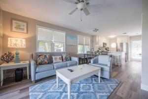 a living room with a couch and a table at ISLAND TIME ON THE GREEN in Key West