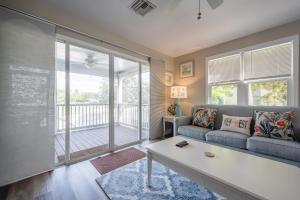 a living room with a couch and a large window at ISLAND TIME ON THE GREEN in Key West