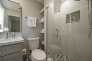 a bathroom with a toilet and a glass shower at ISLAND TIME ON THE GREEN in Key West +38 photos