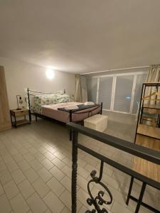 a bedroom with a bed and a table in it at Casa FATA MELANIA-free parking-self check in in Tavernerio