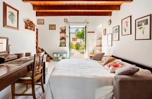 a dining room with a large white table and chairs at Casa DAFNE in Lipari