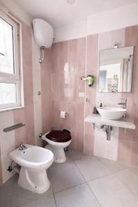 a bathroom with a toilet and a sink at Diana Flavia Suites in Pozzuoli