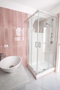 a bathroom with a shower and a white sink at Diana Flavia Suites in Pozzuoli
