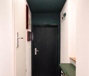 a black door in a hallway with a green counter at SOLO by Tendo Stay - Comfort Housing in Falkensee