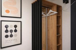 a room with two framed posters and a closet at SOLO by Tendo Stay - Comfort Housing in Falkensee