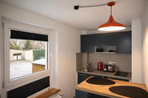 a kitchen with a sink and a window at SOLO by Tendo Stay - Comfort Housing in Falkensee