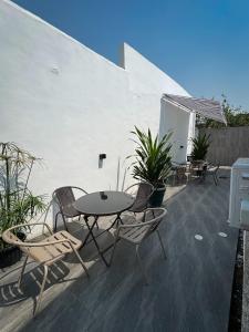 a patio with a table and chairs and plants at MAISON 9 Apartments Surulere in Lagos