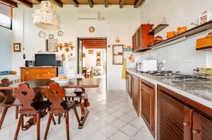 a kitchen with a table and chairs and a dining room at Casa DAFNE in Lipari