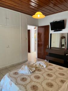 a living room with a bed and a piano at Poseidon Beach Bar & Restaurant Apartments in Paleokastritsa