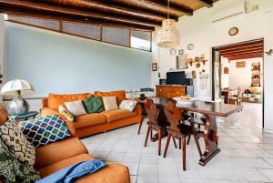 a living room with a couch and a table at Casa DAFNE in Lipari +20 photos