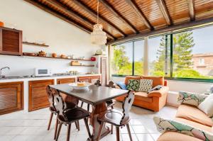 a kitchen and living room with a table and chairs at Casa DAFNE in Lipari