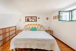 a bedroom with a large bed and two windows at Casa DAFNE in Lipari