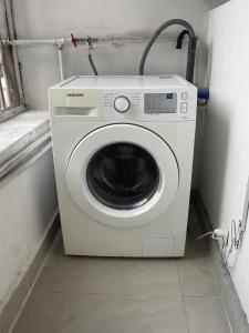 a washing machine in a small room with a window at Downtown Gombe Haut-Commandement in Kinshasa +7 photos