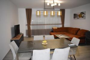a living room with a table and chairs and a couch at Villa Majra in Valbandon