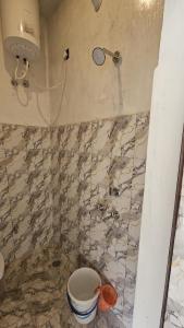 a bathroom with a shower and a toilet in it at Chill and Cheers Resort in Dehradun +15 photos