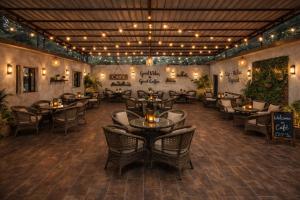 a restaurant with tables and chairs in a room at Chill and Cheers Resort in Dehradun