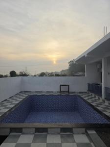 a swimming pool on the roof of a house at Chill and Cheers Resort in Dehradun