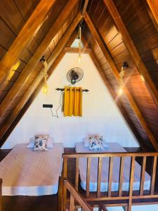 two beds in the attic of a house at Sinharaja Brook Cabana in Deniyaya