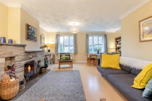 a living room with a couch and a fireplace at 3 Bed in Worth Matravers oc-wy334 in Worth Matravers