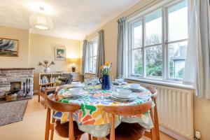 a dining room with a table and chairs and a fireplace at 3 Bed in Worth Matravers oc-wy334 in Worth Matravers
