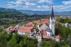 an aerial view of a small town with a church at Hiša Linhart, Hotel & Restaurant in Radovljica